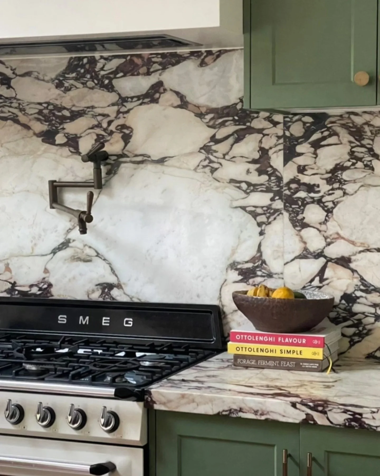 Calacatta Viola marble splashback and benchtop behind a cream range cooker